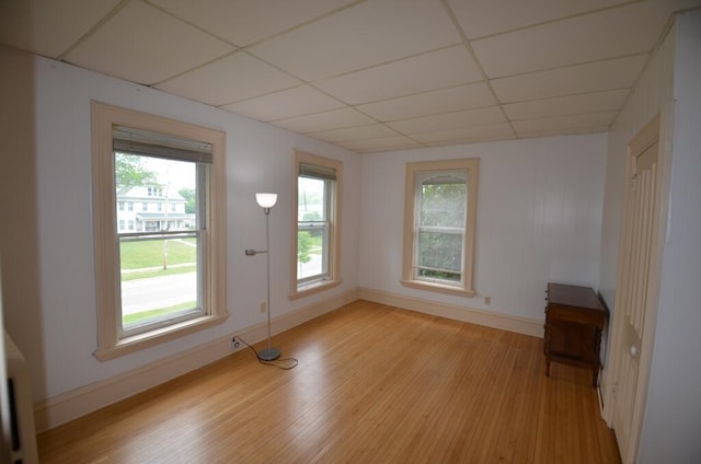 727 W Center St, Whitewater, WI 53190 - unfurnished room featuring a paneled ceiling, light wood finished floors, and plenty of natural light