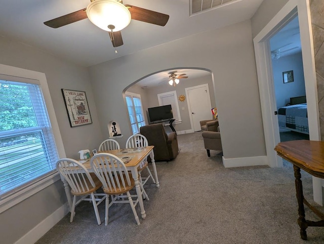 219 Guenther St, Oshkosh, WI 54902 - carpeted dining room with arched walkways and ceiling fan