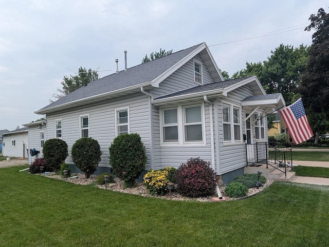 219 Guenther St, Oshkosh, WI 54902 - view of property exterior featuring a yard and a shingled roof