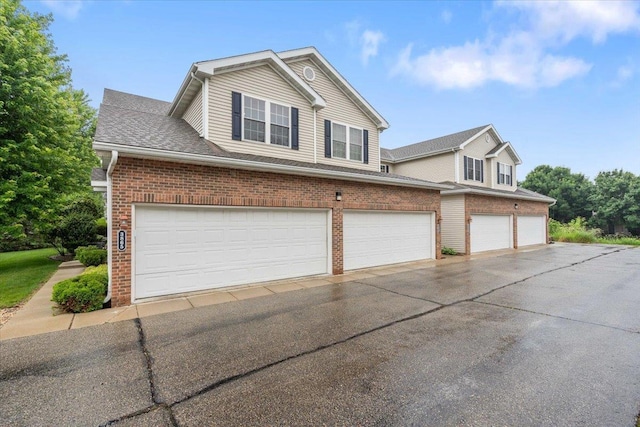 3869 Maple Grove Dr, Madison, WI 53719 - view of front of property featuring brick siding, driveway, and an attached garage