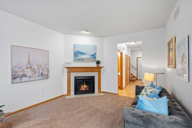 3869 Maple Grove Dr, Madison, WI 53719 - living area with a fireplace with flush hearth, stairway, and carpet floors
