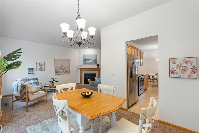 3869 Maple Grove Dr, Madison, WI 53719 - dining room with a warm lit fireplace, a chandelier, and light carpet