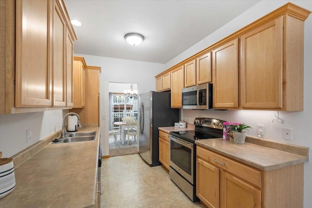 3869 Maple Grove Dr, Madison, WI 53719 - kitchen with stainless steel appliances, a chandelier, light countertops, and light brown cabinets