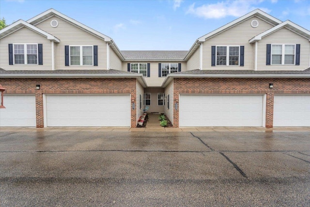 3869 Maple Grove Dr, Madison, WI 53719 - townhome / multi-family property featuring brick siding, a garage, and driveway