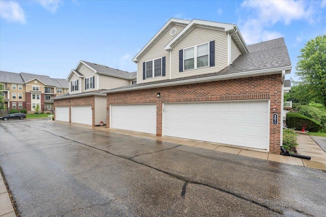 3869 Maple Grove Dr, Madison, WI 53719 - view of front facade featuring brick siding, a garage, and driveway