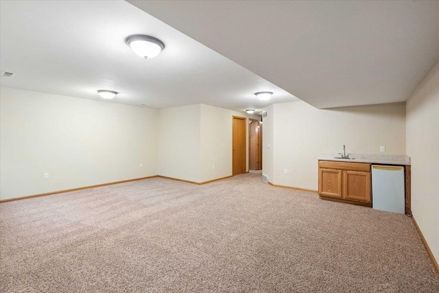 3869 Maple Grove Dr, Madison, WI 53719 - finished below grade area featuring bar with sink and light colored carpet