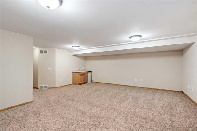 3869 Maple Grove Dr, Madison, WI 53719 - finished below grade area featuring light colored carpet and bar with sink