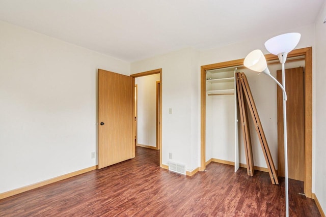 10268 W Parkedge Cir, Franklin, WI 53132 - unfurnished bedroom featuring dark wood-style flooring and baseboards