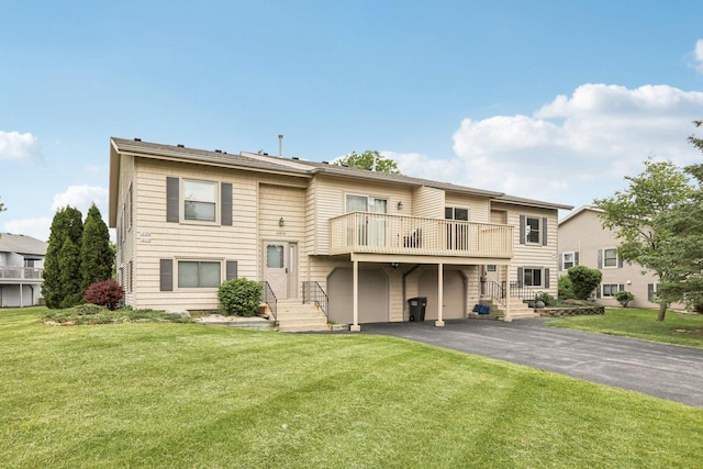 10268 W Parkedge Cir, Franklin, WI 53132 - back of house featuring a balcony, asphalt driveway, a lawn, and an attached garage