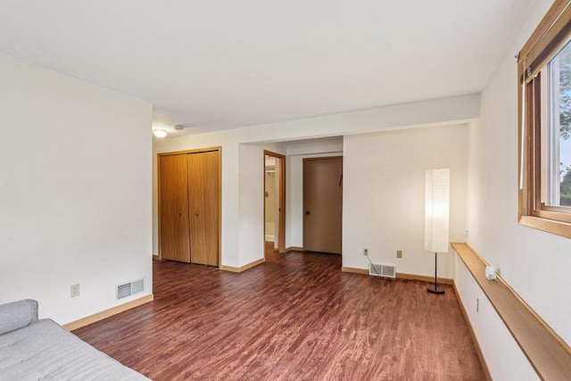 10268 W Parkedge Cir, Franklin, WI 53132 - unfurnished living room featuring dark wood-style floors and baseboards