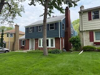 6265 N Bay Ridge Ave, Whitefish Bay, WI 53217 - colonial house with a front yard and a chimney