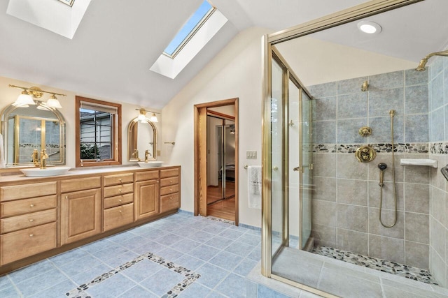 6265 N Bay Ridge Ave, Whitefish Bay, WI 53217 - bathroom featuring a skylight, a shower stall, vaulted ceiling, double vanity, and tile patterned floors
