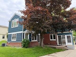 6265 N Bay Ridge Ave, Whitefish Bay, WI 53217 - rear view of house with a lawn and brick siding