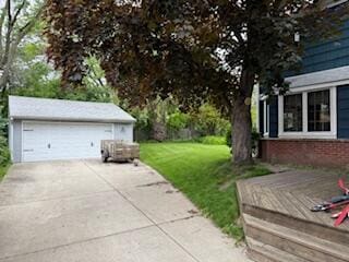 6265 N Bay Ridge Ave, Whitefish Bay, WI 53217 - view of grassy yard featuring a wooden deck, a detached garage, and an outdoor structure