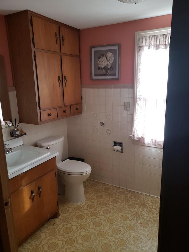 809 N 5th Ave, Wausau, WI 54401 - bathroom featuring tile walls, vanity, tile patterned floors, and wainscoting