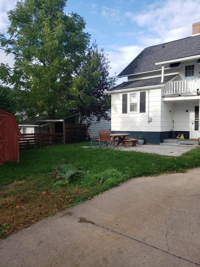 809 N 5th Ave, Wausau, WI 54401 - view of home's exterior with roof with shingles, a chimney, and a balcony