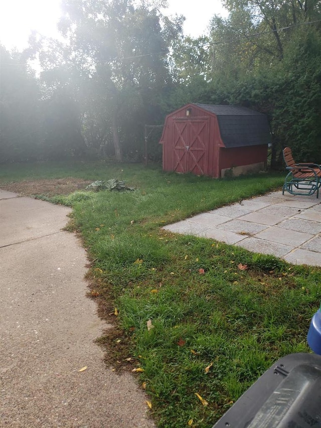 809 N 5th Ave, Wausau, WI 54401 - view of green lawn with a storage unit and a patio
