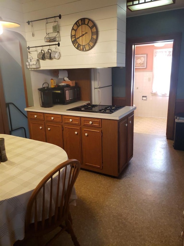 809 N 5th Ave, Wausau, WI 54401 - kitchen featuring black appliances, light countertops, and brown cabinetry