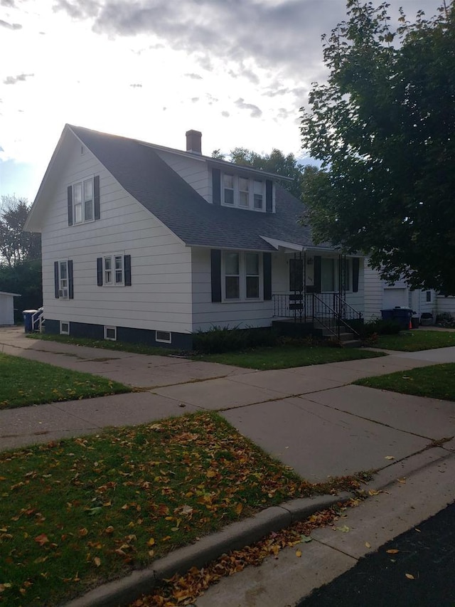 809 N 5th Ave, Wausau, WI 54401 - view of front facade with a chimney, covered porch, and roof with shingles