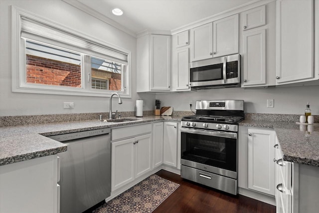 150 E Fairmount Ave, Whitefish Bay, WI 53217 - kitchen with appliances with stainless steel finishes, white cabinetry, dark wood-style flooring, and light stone counters