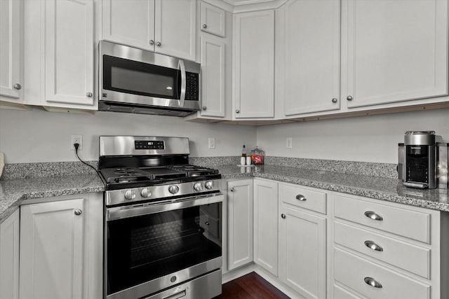 150 E Fairmount Ave, Whitefish Bay, WI 53217 - kitchen featuring appliances with stainless steel finishes, white cabinetry, and light stone counters