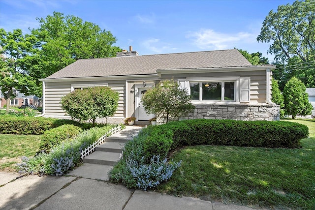 150 E Fairmount Ave, Whitefish Bay, WI 53217 - view of front of house featuring a front lawn, stone siding, and a chimney