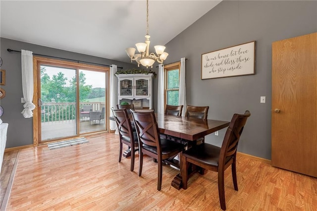 10525 Voight Rd, Fall Creek, WI 54742 - dining room featuring a chandelier, healthy amount of natural light, lofted ceiling, and light wood-type flooring