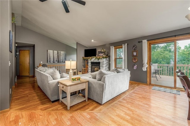 10525 Voight Rd, Fall Creek, WI 54742 - living area featuring a fireplace, ceiling fan, light wood finished floors, and lofted ceiling