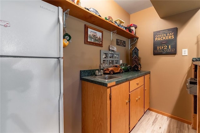 10525 Voight Rd, Fall Creek, WI 54742 - kitchen featuring freestanding refrigerator, open shelves, light wood-type flooring, dark countertops, and brown cabinets