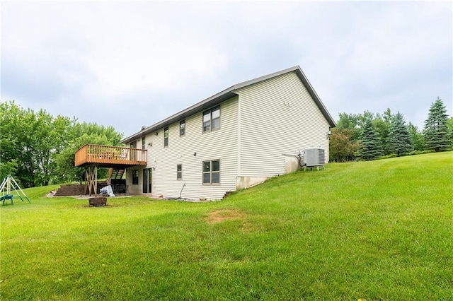 10525 Voight Rd, Fall Creek, WI 54742 - rear view of property with a wooden deck, a fire pit, and a yard