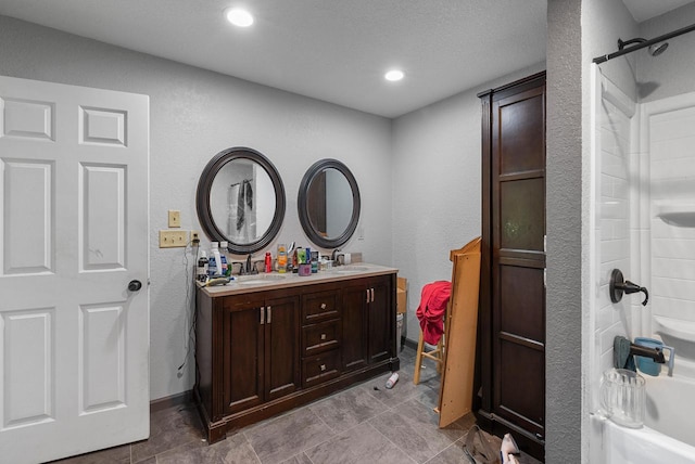 N7082 Airport Rd, Beaver Dam, WI 53916 - bathroom featuring double vanity, shower / tub combination, recessed lighting, and a textured wall