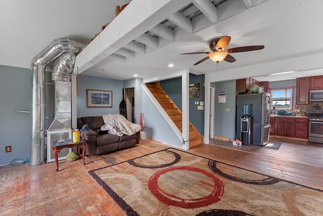 N7082 Airport Rd, Beaver Dam, WI 53916 - living area featuring hardwood / wood-style floors, stairs, a ceiling fan, and recessed lighting