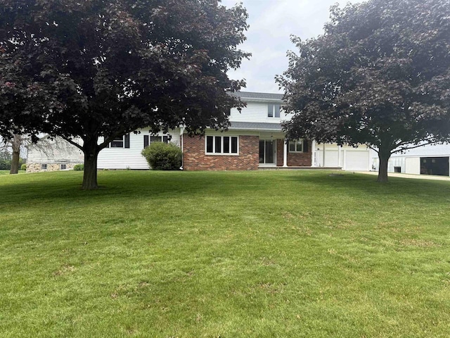 8478 N Brown County Line Rd, Pulaski, WI 54162 - view of front facade with a garage, a front yard, and brick siding