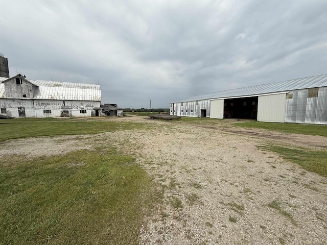 8478 N Brown County Line Rd, Pulaski, WI 54162 - view of community featuring dirt driveway, an outbuilding, and a detached garage