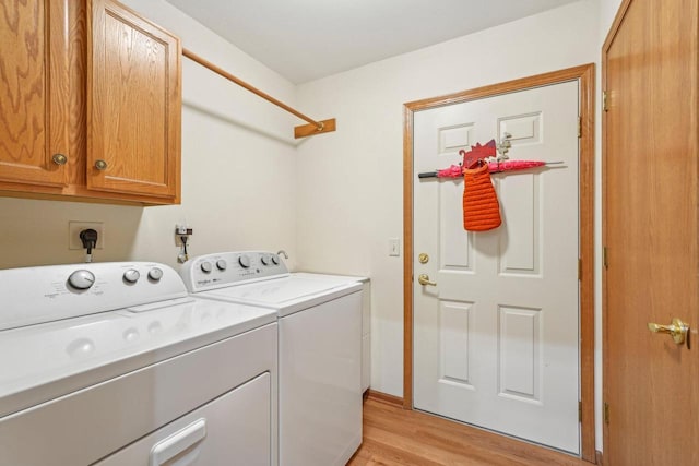 1910 Cedar St, Grafton, WI 53024 - washroom with cabinet space, independent washer and dryer, and light wood-style flooring