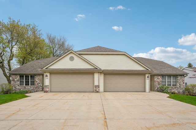 1910 Cedar St, Grafton, WI 53024 - view of front facade featuring an attached garage, concrete driveway, and stone siding