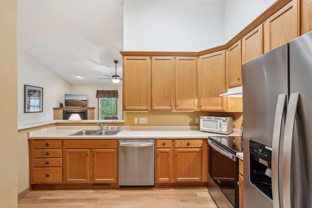 1910 Cedar St, Grafton, WI 53024 - kitchen with appliances with stainless steel finishes, light wood-style flooring, ceiling fan, light countertops, and a peninsula