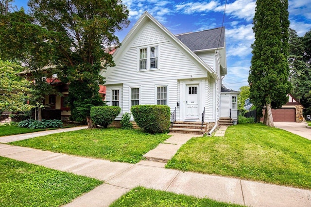 222 N Union St, Appleton, WI 54911 - view of front of house with a front yard, an outdoor structure, a shingled roof, and a garage