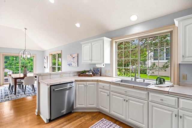 N53W16527 Whitetail Run, Menomonee Falls, WI 53051 - kitchen featuring stainless steel dishwasher, a peninsula, white cabinets, vaulted ceiling, and recessed lighting