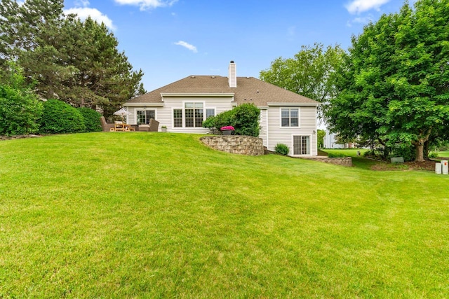 N53W16527 Whitetail Run, Menomonee Falls, WI 53051 - back of property with a chimney, a yard, and a patio