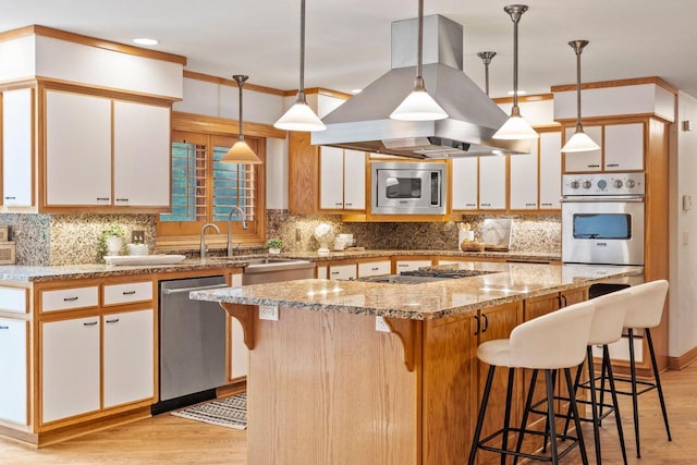 13835 Stonefield Ct, Elm Grove, WI 53122 - kitchen featuring appliances with stainless steel finishes, island range hood, light wood-style floors, white cabinets, and decorative backsplash