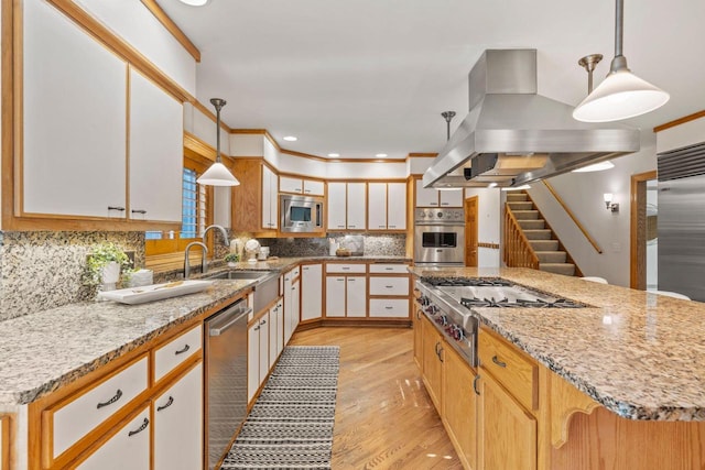 13835 Stonefield Ct, Elm Grove, WI 53122 - kitchen with island exhaust hood, stainless steel appliances, light stone countertops, light wood-style flooring, and decorative backsplash
