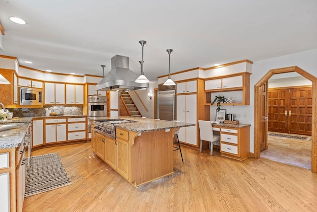 13835 Stonefield Ct, Elm Grove, WI 53122 - kitchen with island exhaust hood, built in appliances, open shelves, decorative backsplash, and light stone counters