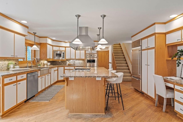 13835 Stonefield Ct, Elm Grove, WI 53122 - kitchen featuring built in appliances, island exhaust hood, backsplash, light stone counters, and a kitchen breakfast bar