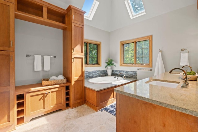 13835 Stonefield Ct, Elm Grove, WI 53122 - bathroom featuring a skylight, a bath, vanity, and high vaulted ceiling