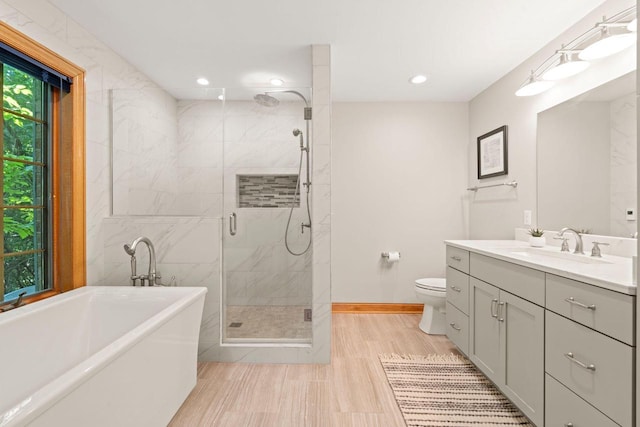 13835 Stonefield Ct, Elm Grove, WI 53122 - full bathroom with a soaking tub, vanity, a stall shower, recessed lighting, and wood finished floors