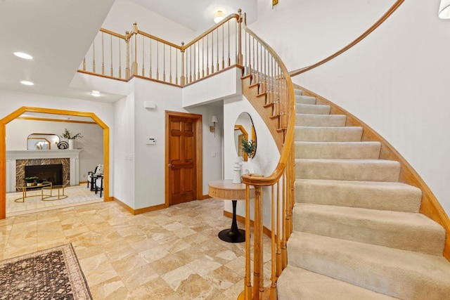 13835 Stonefield Ct, Elm Grove, WI 53122 - staircase with recessed lighting, a premium fireplace, and a high ceiling