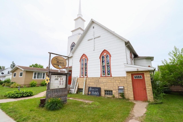 134S Main St, Stoddard, WI 54658 - split level home with a front yard, a chimney, and stone siding