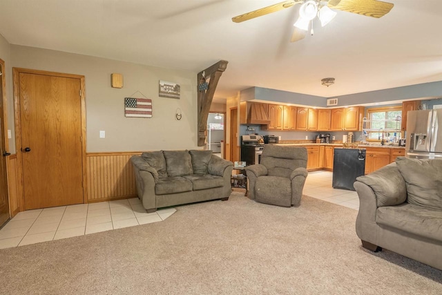 N3315 Brook Dr, Medford, WI 54451 - living area featuring light tile patterned flooring, a wainscoted wall, light colored carpet, and ceiling fan