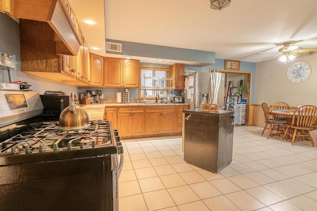 N3315 Brook Dr, Medford, WI 54451 - kitchen featuring stainless steel appliances, ceiling fan, light countertops, light tile patterned floors, and wainscoting